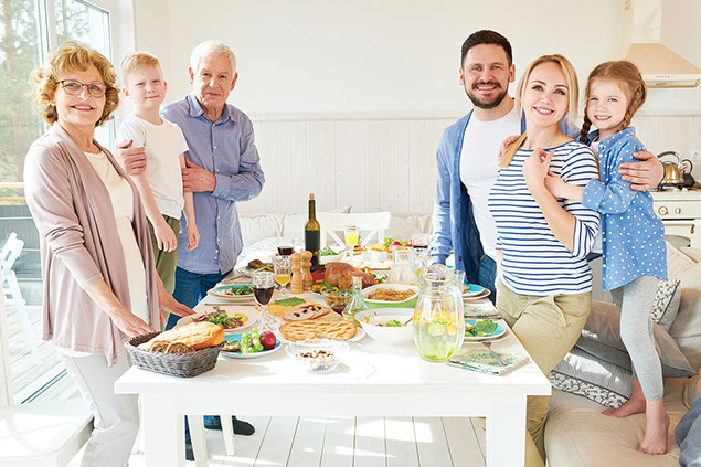 Image of family around the dinner table.