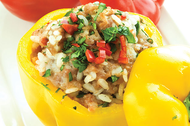 Image of yellow and red peppers stuffed with rice and other vegetables.