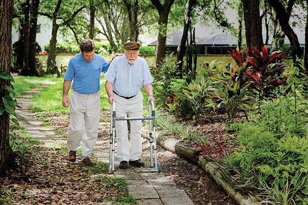 Image of son walking with elderly father.