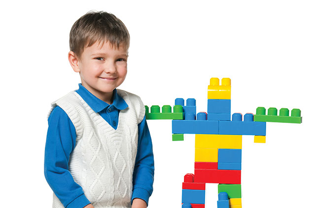 Image of young boy playing with blocks.