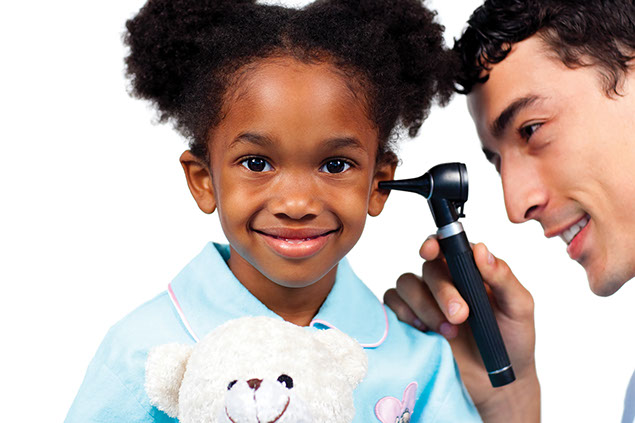Image of doctor looking into a child's ear.