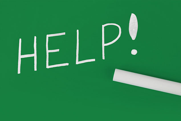 Image of the word "Help" spelled out on a green chalk board.