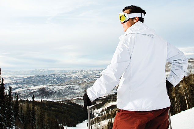 Image of man on top of a skiing slope.