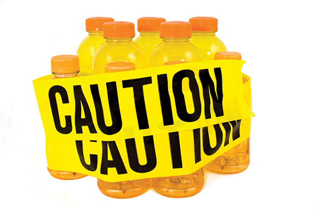 Image of sport drinks with yellow "Caution" tape wrapped around the bottles.