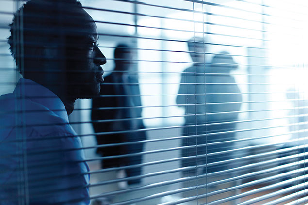 Image of a business man looking off the distance.