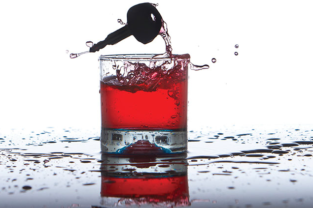 Image of an alcoholic drink with a car key.