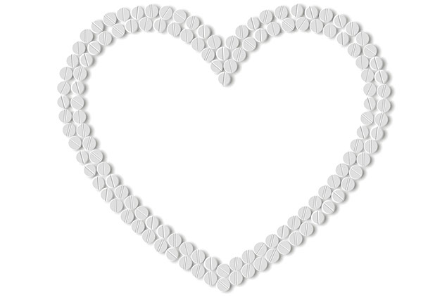 Image of aspirins shaped into a heart.