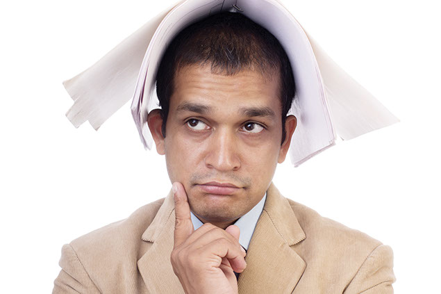 Image of business man with a notebook over his head.