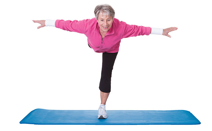 Image of older women balancing on one leg while bending over half way.