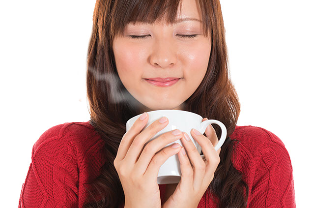 Image of women of a hot cup of tea.
