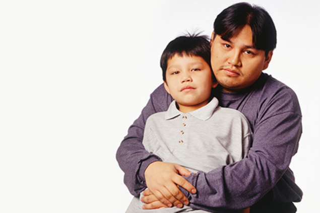 Image of father hugging son.