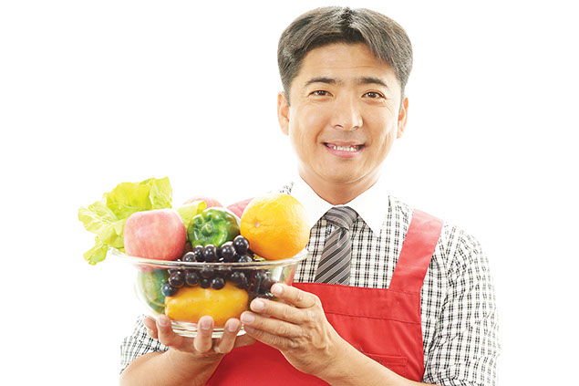 Image of man holding a bowl of fruit.
