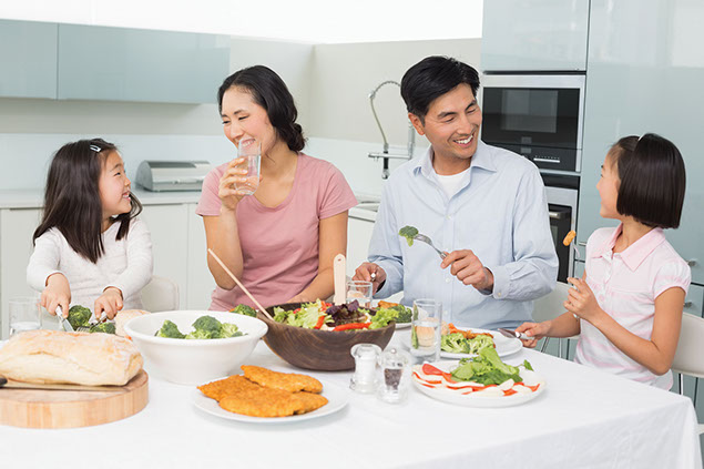 Image of family eating dinner at the kitchen table.