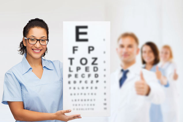 Image of doctor holding up an eye chart.