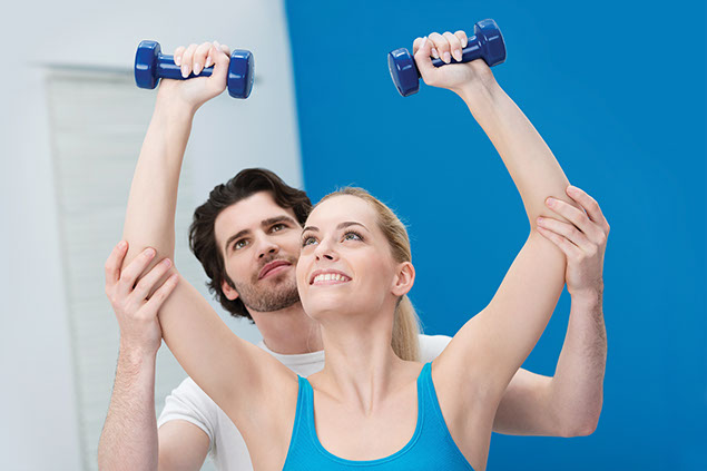 Image of women and trainer exercising the shoulders.