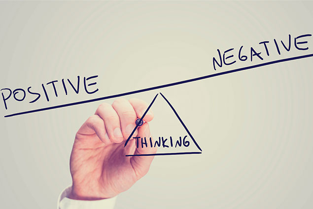 Image of a hand drawing 'Positive', 'Negative' and 'Thinking' as a seesaw.
