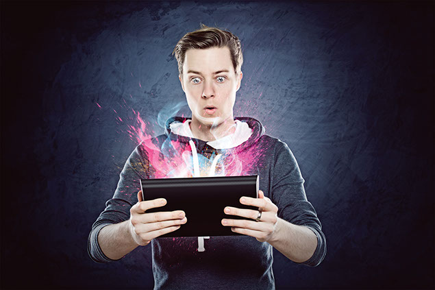 Image of young man with colors popping out of his tablet.