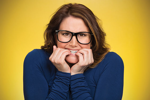 Image of women biting her finger nails.