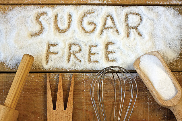 Image of sugar spilled out on a table with the words "Sugar Free" spelled out.