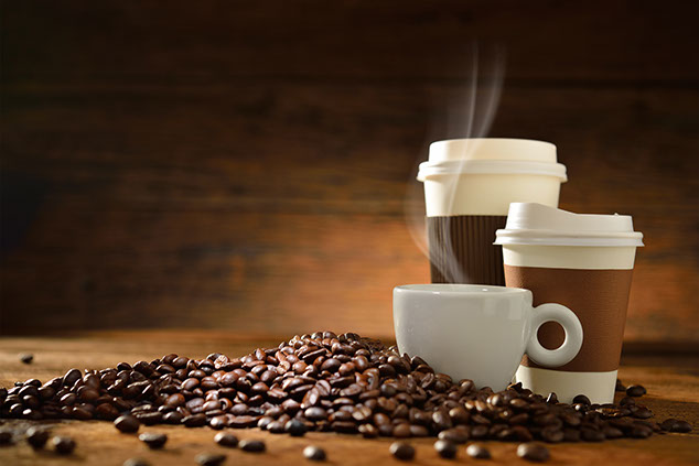 Image of 3 coffee cups around coffee beans.