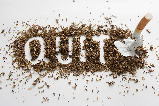Image of the word "Quit" spelled within a pile of tobacco with a crused cigarette.