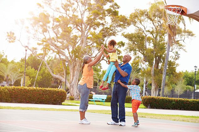 Image of grandparents playing basketball with grandkids.