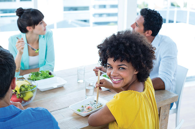 Image of co-workers wating lunch together.
