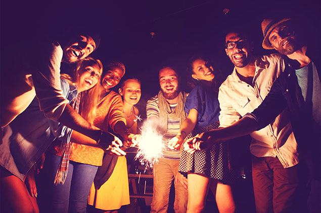 Image of a group of friends with sparkler fireworks.