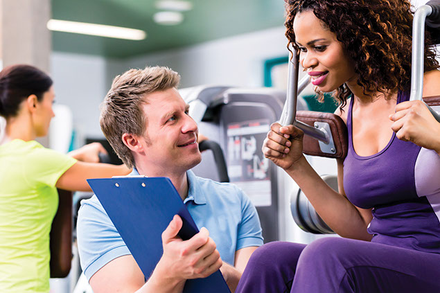 Image of person at gym with a trainer.