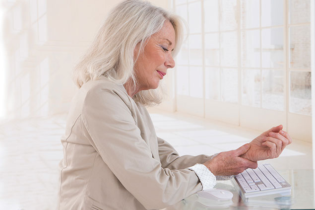 Image of women holding wrist in pain.