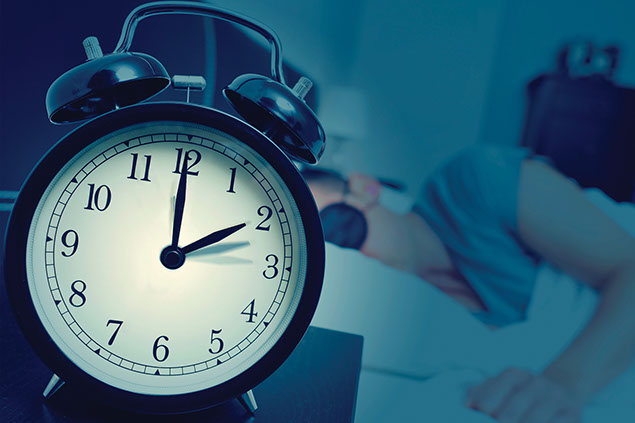 Image of clock with person sleeping.