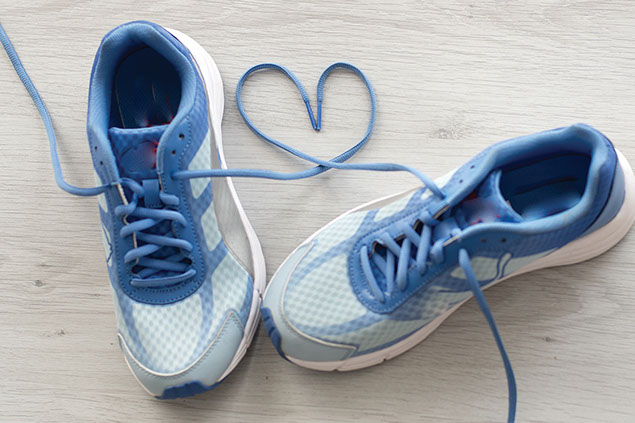 Image of gym shoes with laces shaped as a heart.
