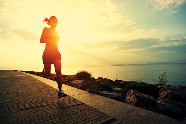 Image of women running during sunset.