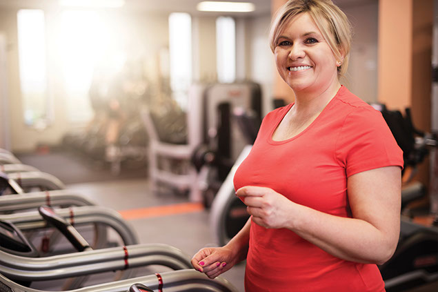 Image of women using treadmill at a gym.