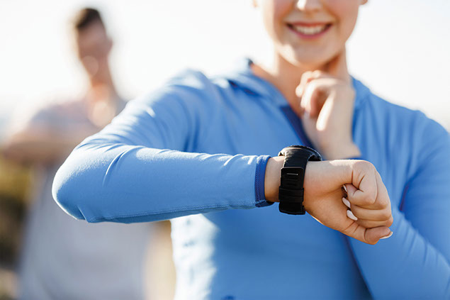 Image of female checking heart rate.
