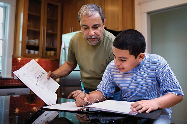 Image of father helping son with homework.