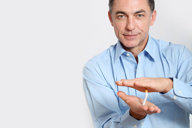 Image of man crushing a cigarette.