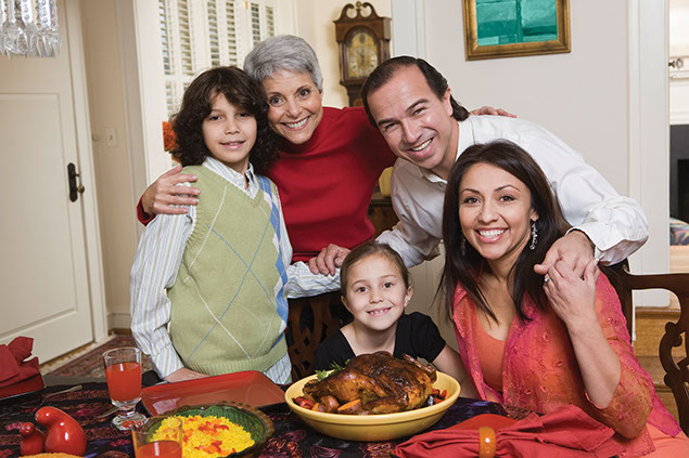 Image of multi-generation family about to have dinner.