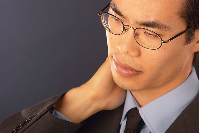 Image of business man holding his neck.