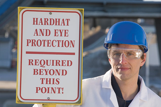 Image of worder wearing proper hard-hat and protective eye glasses.