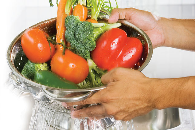 Image of vegetables being washed in a scrubber.