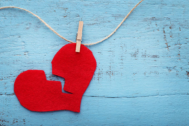Image of broken cloth heart on string.