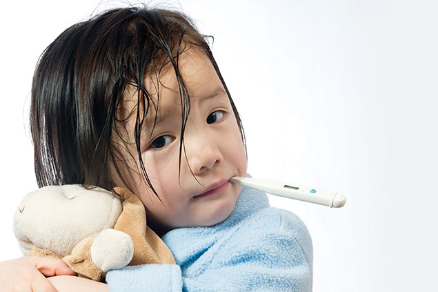 Image of a child having her temperature checked.