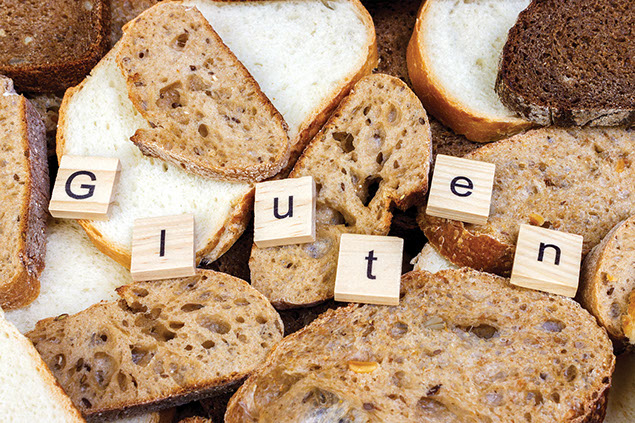 Image of bread with the word 'Gluten' on wooden blocks.