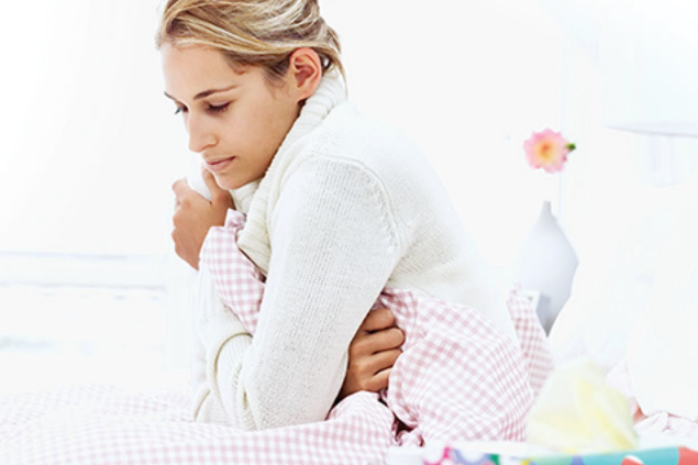 Image of women sick in bed.