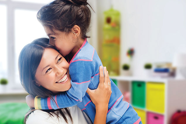 Young child hugging mother.