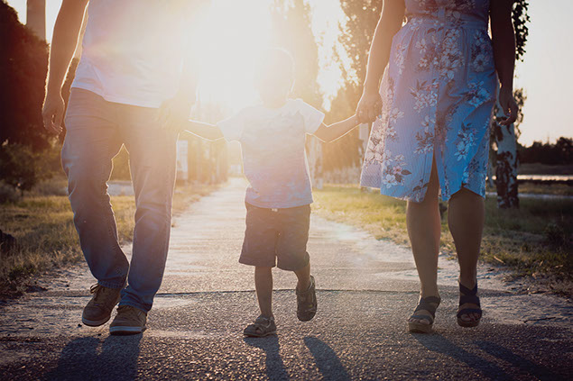 Image of family waking along sidewalk.