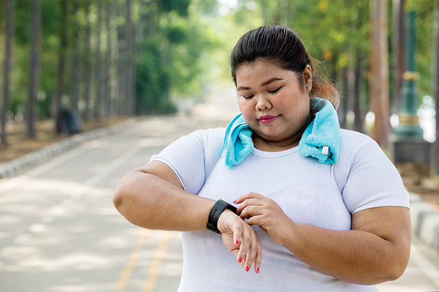 Women looking at watch before exercising.