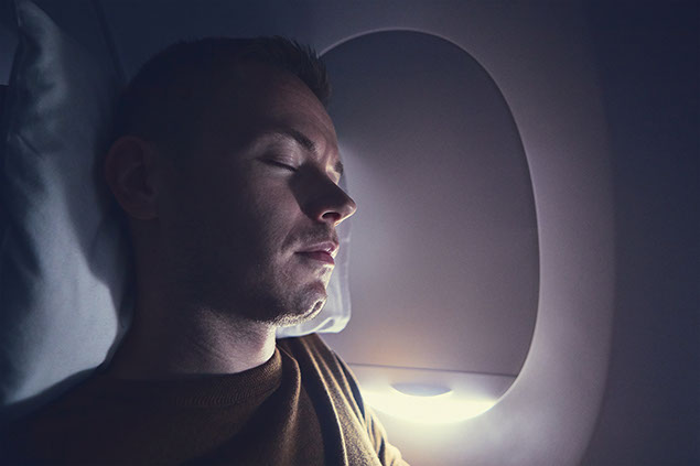 Man sleeping on plane.