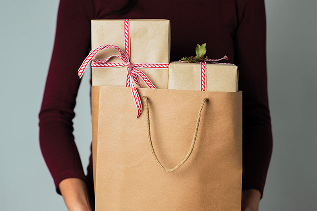Person holding a bag of gifts.